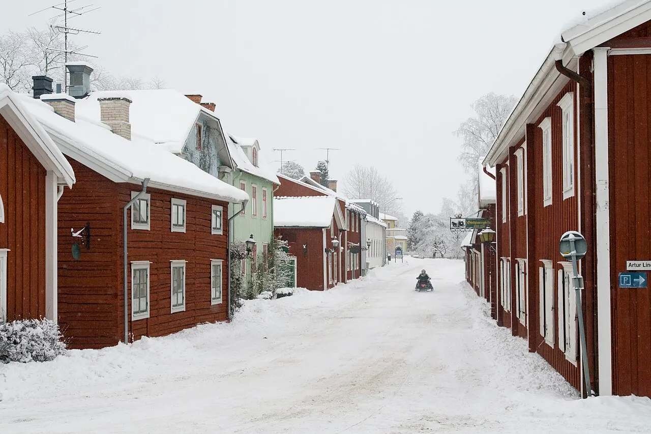 En skoter åker förbi Gästgivargården på Prästgatan i Grythyttan.